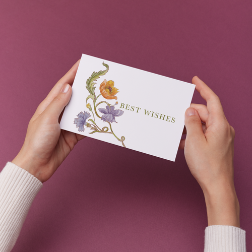 Hands holding a card with an original purple and rust floral design and 'Best Wishes' text 